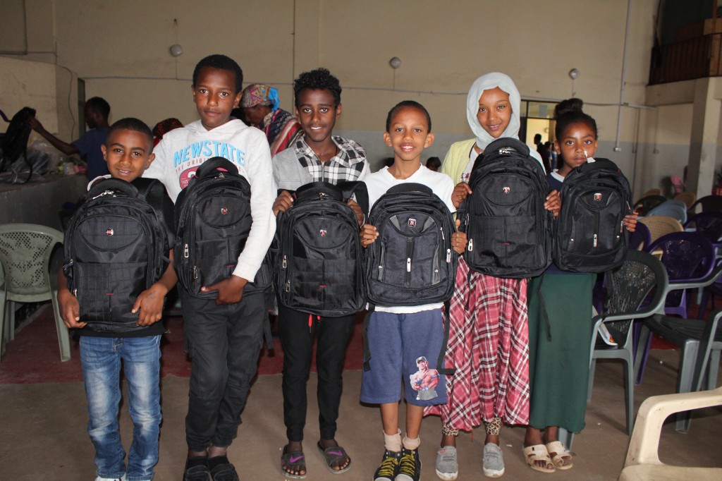Children receiving school bag distribution support